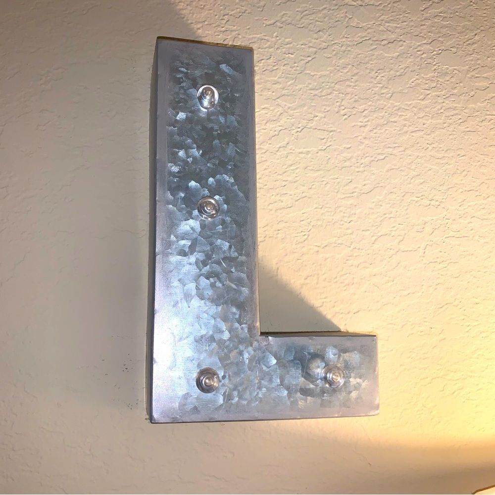 Metal lighted initial “L”